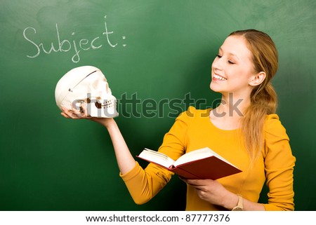 Female student holding skull and book