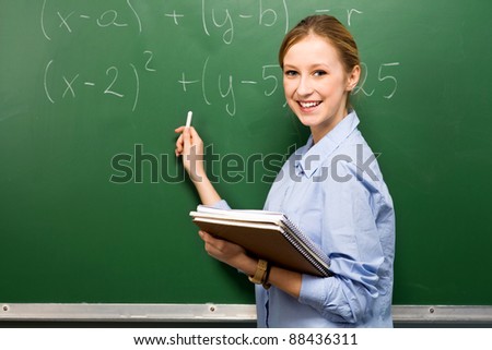 Female Student Doing Math on Chalkboard