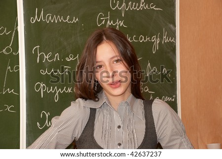 Russian schoolgirl performs the task at the blackboard