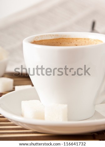 cup of coffee, sugar and newspaper closeup