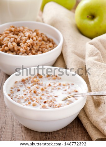 Buckwheat porridge with milk on a wooden table