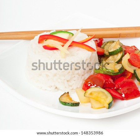 Plate of vegetable fried rice and chopstick.