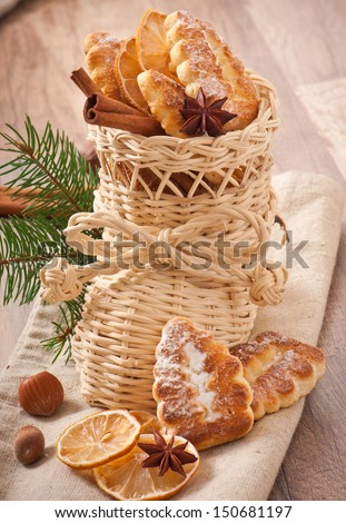 Wicker Christmas stocking filled with cookies, cinnamon sticks, candied lemon and star anise