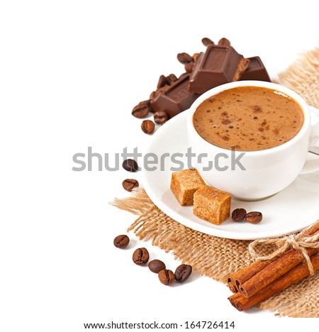 Closeup cup of italian espresso with cinnamon, coffee beans, brown sugar and chocolate isolated on white background