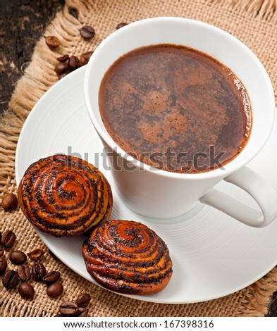 Cup of coffee and biscuits with poppy seeds
