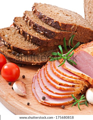 Ham, bread and spices on wooden board.