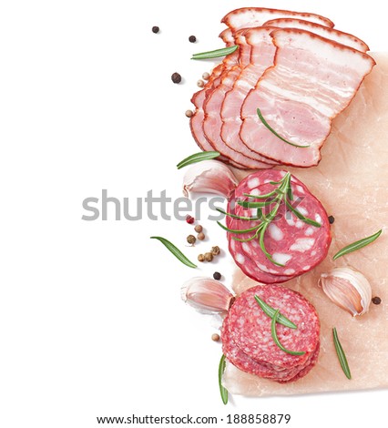 Assorted deli meats, rosemary and pepper, isolated on white