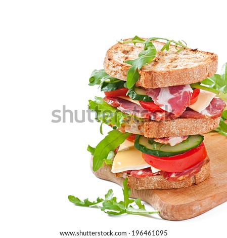 Sandwich with ham, cheese and fresh vegetables on white background