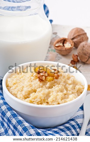 Porridge in a bowl with nuts and raisins
