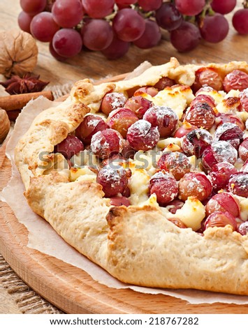 Galette with grapes and cheese sprinkled with powdered sugar