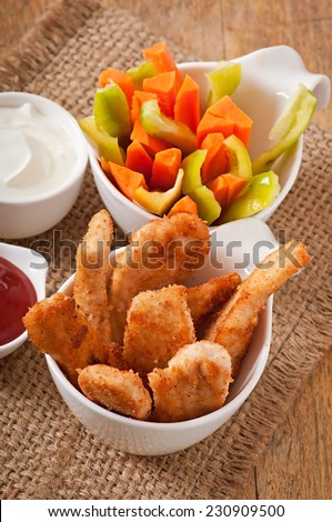 Chicken nuggets with sauce and vegetables