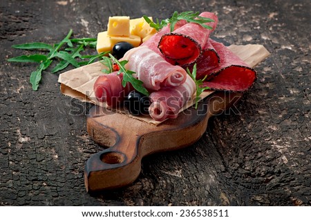 Meat appetizer  on old wooden background