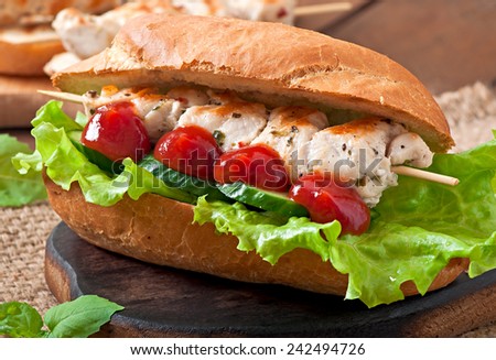 Big sandwich with chicken kebab and lettuce