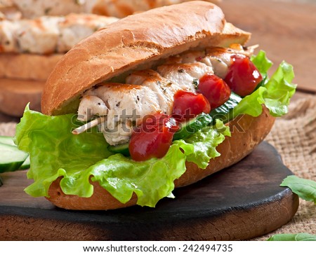 Big sandwich with chicken kebab and lettuce