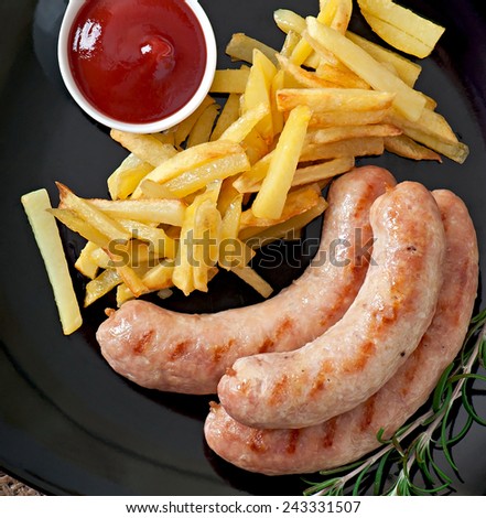 Chicken sausages grilled with a side dish of french fries