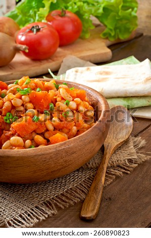 Stewed white beans and sliced pumpkin in tomato sauce