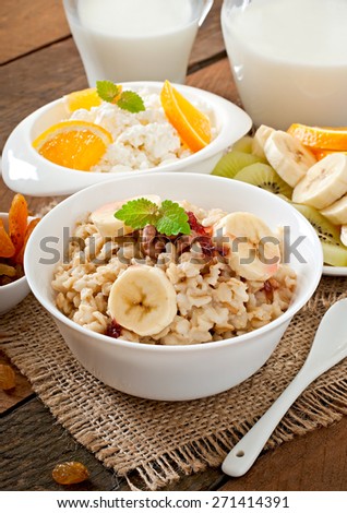 Healthy breakfast - oatmeal, cottage cheese, milk and fruit