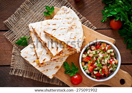 Mexican Quesadilla wrap with chicken, corn and sweet pepper and salsa