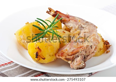 Oven Baked rabbit legs with potatoes and rosemary