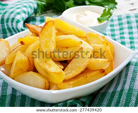 Fried potato wedges in white bowl