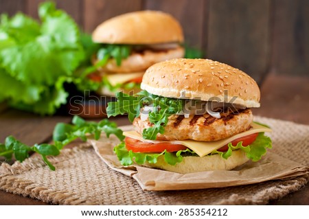 Sandwich with chicken burger, tomatoes, cheese and lettuce