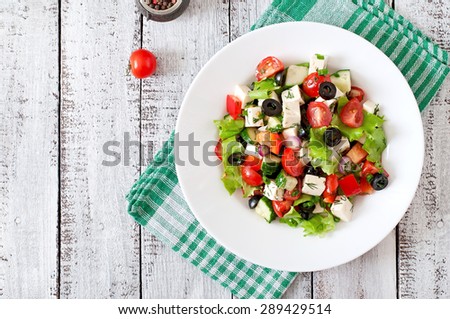 Greek salad  with fresh vegetables, feta cheese and black olives. Top view