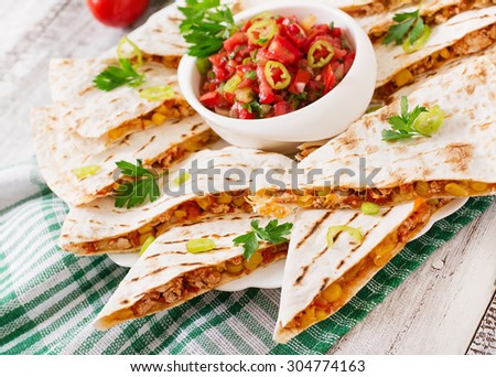 Mexican Quesadilla wrap with chicken, corn and sweet pepper and salsa. Top view