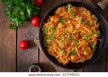 Pasta linguine with meatballs in tomato sauce. Top view