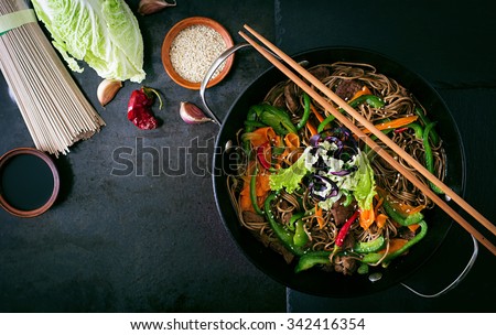 Soba noodles with beef, carrots, onions and sweet peppers. Top view