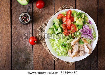 Dietary salad with chicken, avocado, cucumber, tomato and Chinese cabbage. Top view