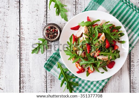Chicken salad with arugula and strawberries. Top view