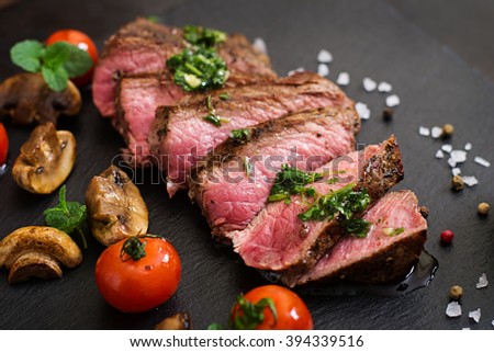Juicy steak medium rare beef with spices and grilled vegetables.