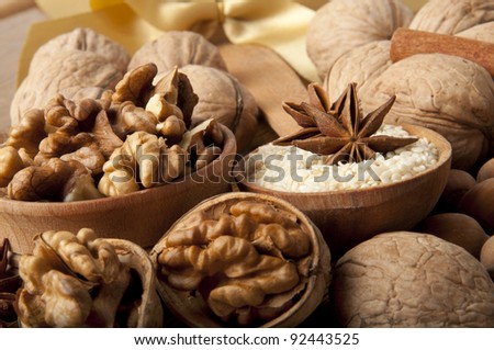 Wood nut, walnut, anise, cinnamon and sesame against a dark background