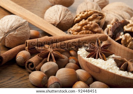 Walnut, wood nut, anise and sesame against a dark background