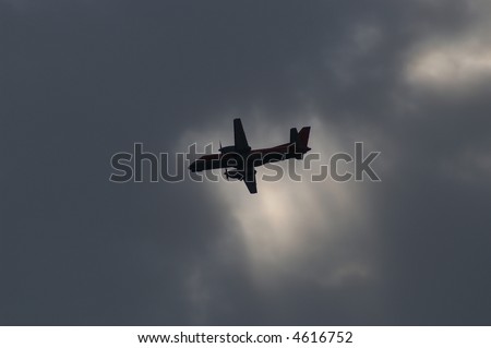 turboprop commuter plane against a dark sky with some sun