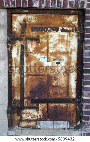 Antique Rusty Steel Door in Brick Wall