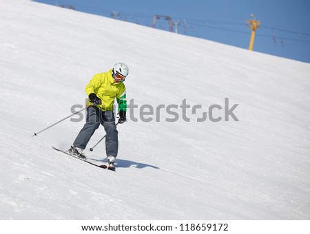 Young man learning to ski on a snowy slope