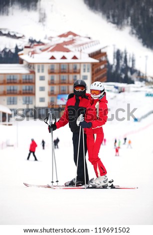 Young couple standing on a ski slope