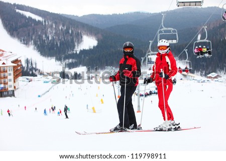 Young couple standing on a ski slope