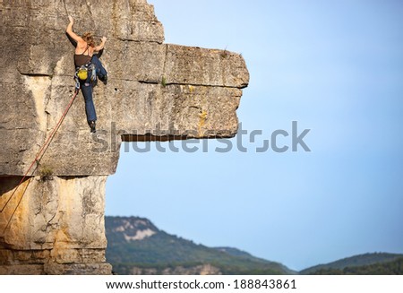 Young female rock climber on a cliff