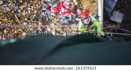 Industrial climber placing exterior advertising, view from above