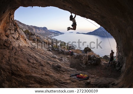 Family rock climber against picturesque view of Telendos Island at sunset. Kalymnos Island, Greece
