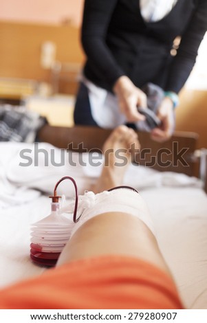 Cropped view of a man after surgery on a leg while lying on a hospital bed