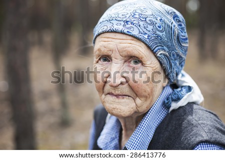 Portrait of an aged woman smiling outdoors