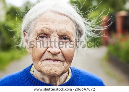 Portrait of an aged woman smiling outdoors
