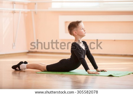 Boy dancer doing exercise at ballet dance class