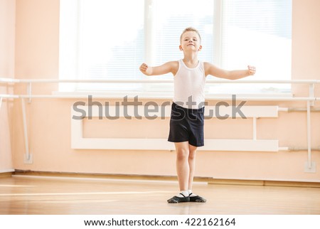 Young boy dancing at a ballet class