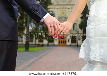 Wedding photo of married couple holding hands