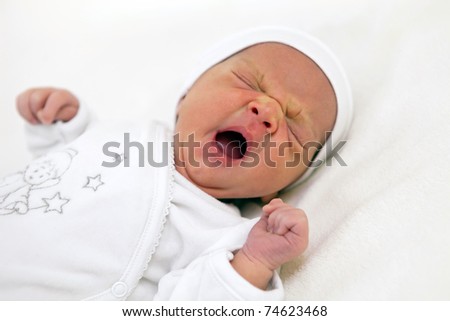 One week old baby boy yawning, close-up shot