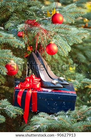 Pair of black women shoes against Christmas tree